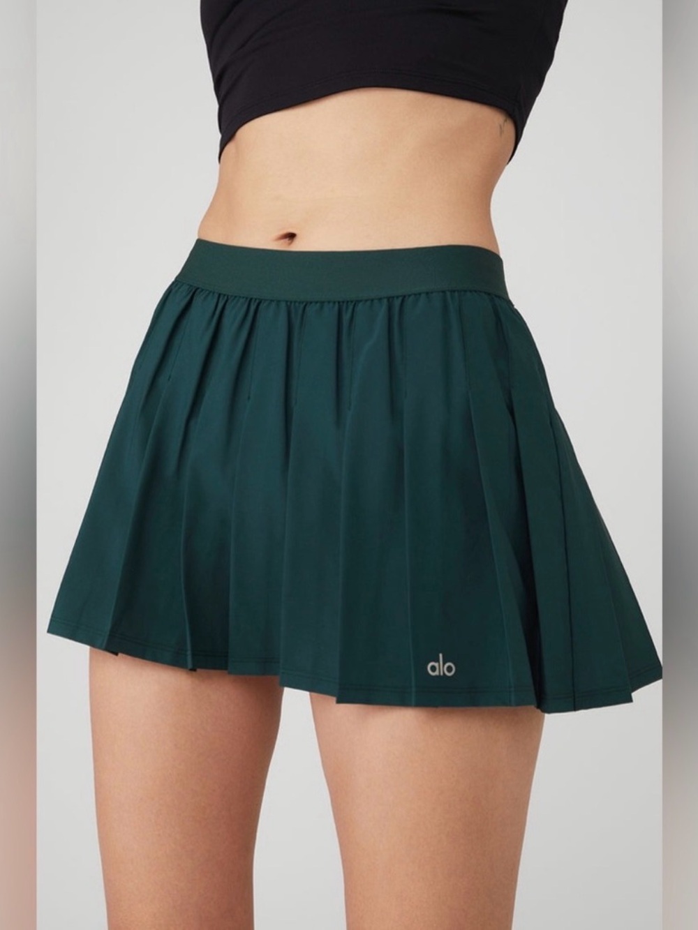 Alo Yoga Varsity Tennis Skirt in the "Midnight Green"
